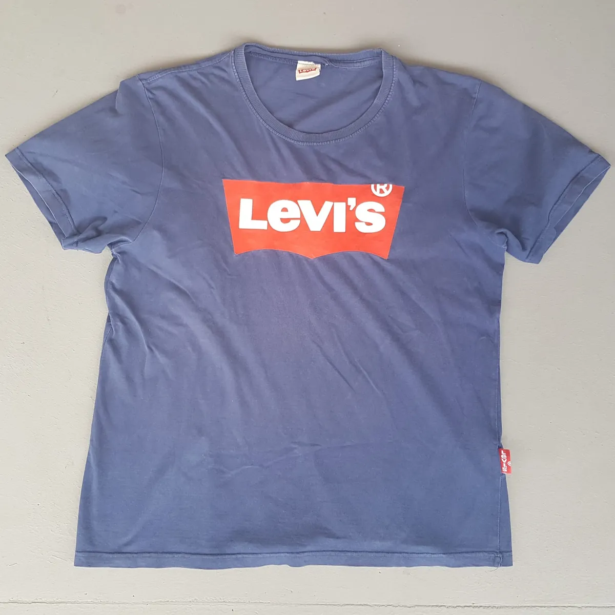 Levi's Vintage Levi’s Strauss T-Shirt, Retro Levi’s Graphic Tee, Cosmopolitan, Cool Blue Crew Neck Top, Iconic Red Batwing Logo, Red Tab Model, Urban Style, Pop Culture, Hip Hop, Rock Star, Sophistication, Streetwise, Everyday Fashion, Timeless Classic