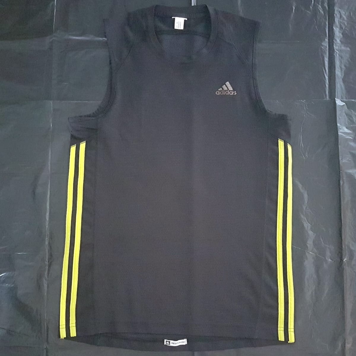 Original ADIDAS T-Shirt, Cool Black Response Singlet, 3 Side Yellow Stripes, Cosmopolitan, Athletic Tank Top, Adidas Sleeveless Shirt, Sleek Design, Sporty Top, Sophistication, Streetwise, Pop Culture, Cult Street Fashion, Urban Style, Timeless Appeal, Active Lifestyle