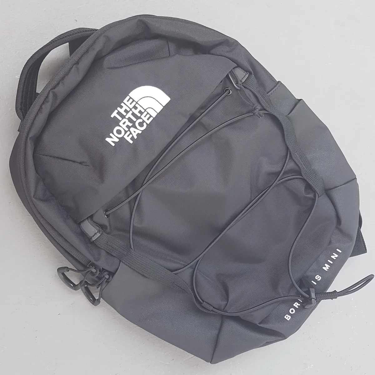 The North Face Backpack, Borealis Mini Model, Black Haversack, Cosmopolitan, Cool Waterproof Design, Travel Classic, Front Bungee Compression System, Padded Back, Smart Organization, Roadster, Sophistication, Everyday Fashion