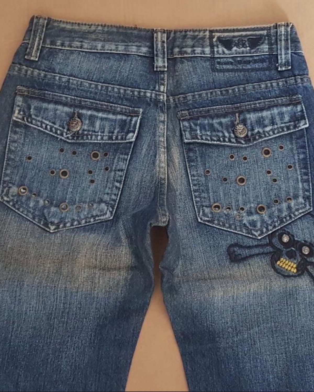 Edgy Denim Jeans with Skull Patch and Stud Details