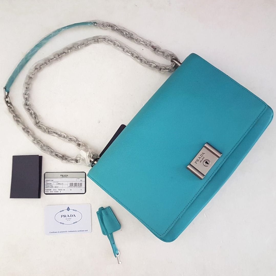 Prada PRADA Vitello Sling Bag, Original Prada Metal Closure, Prada Accordion Lock & Key Model, Made in ITALY, Retail $2400, Chain Strap, Leather Handbag, Sleek Design, Sophistication, Streetwise, Timeless Classic, Luxury Lifestyle, Pop Culture, Catwalk, Runway