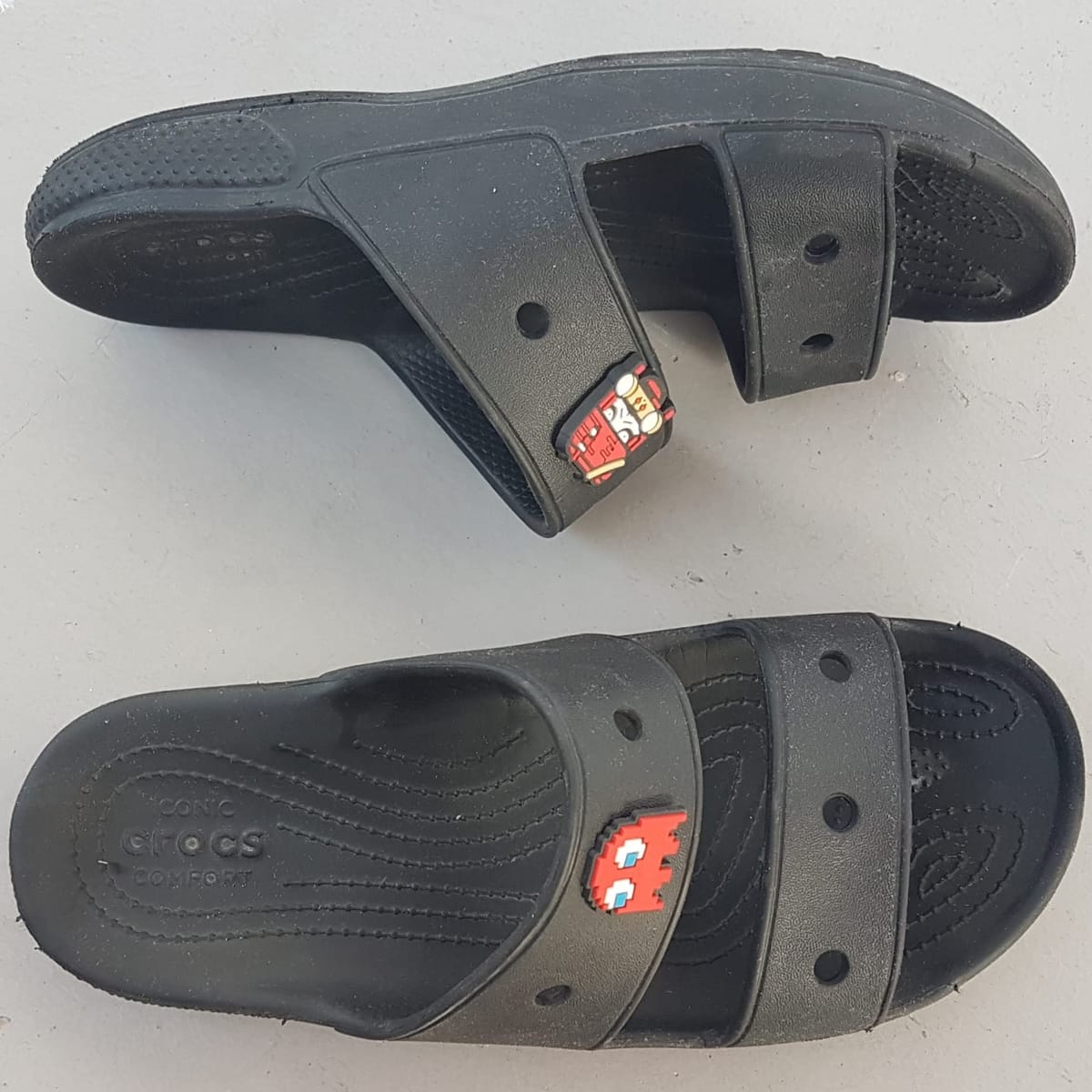 Original CROCS Clogs, Cosmopolitan Sandals, Size US 7 (M) 9 (F) on base, Cool Designer Shoes, Black Clog with 2 Jibbitz Charms, Timeless Appeal, Sleek Sliders, Slip-on, Fun Footwear, Cult Street Fashion, Urban Style, Sophistication, Streetwise, Pop Culture